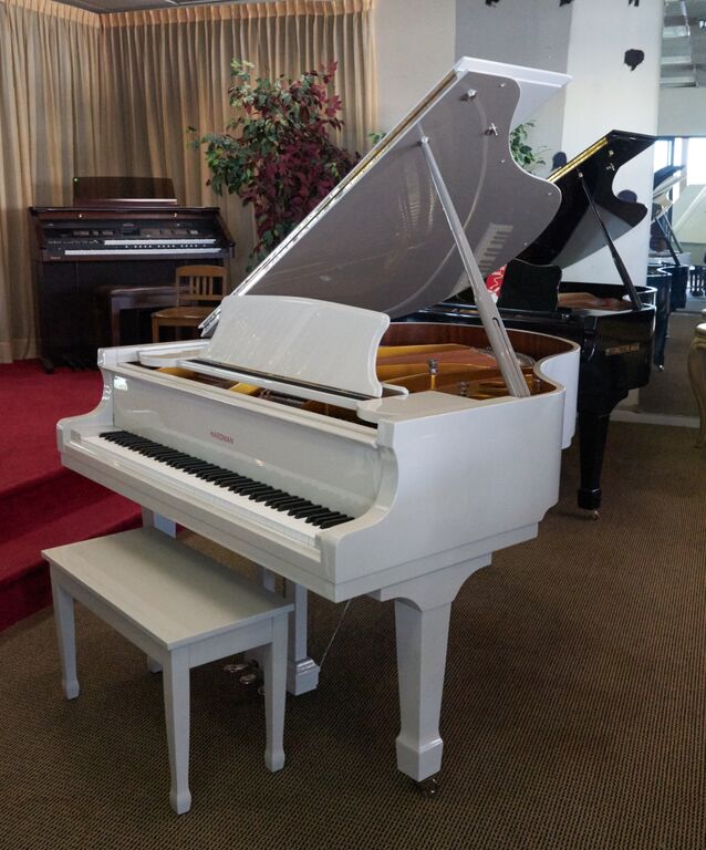 a white baby grand piano